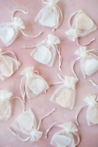 Amarie's bath flowers - petals and gift bags on pink background